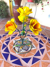 Load image into Gallery viewer, Bright yellow metal rose-shaped flowers with green stems and leaves, on a tiled table.