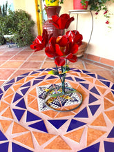 Load image into Gallery viewer, Red metal rose bouquet with green stems on a patterned mosaic tile table in an outdoor patio setting.