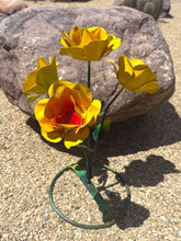 Load image into Gallery viewer, Yellow metal garden flowers with orange and red centers, mounted on a green wire stand.