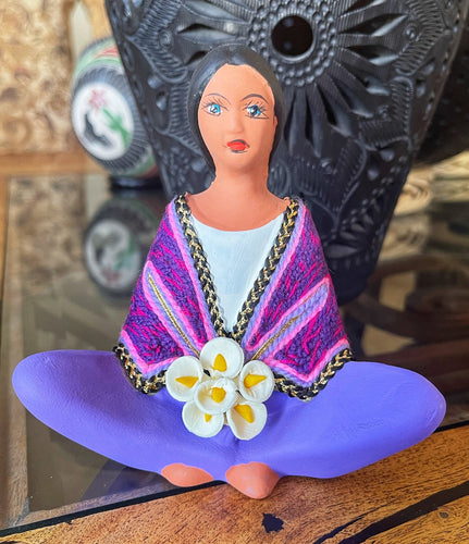 clay doll selling flowers purple shawl