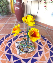 Load image into Gallery viewer, Metal yellow handmade roses with orange centers placed on a mosaic table in a tiled outdoor patio setting.
