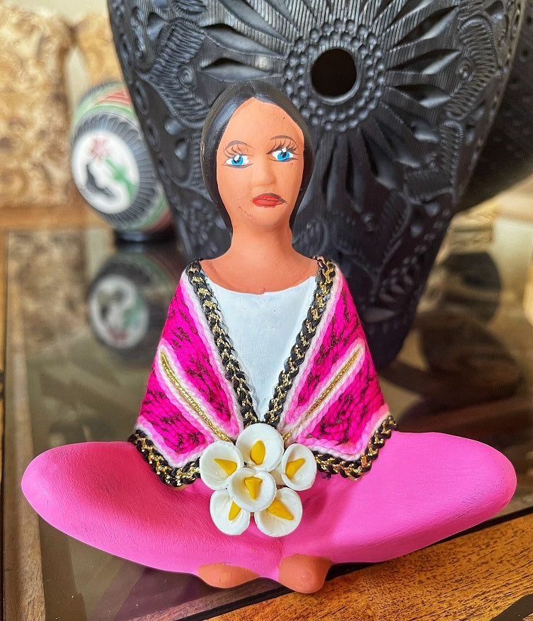 clay doll selling flowers pink shawl