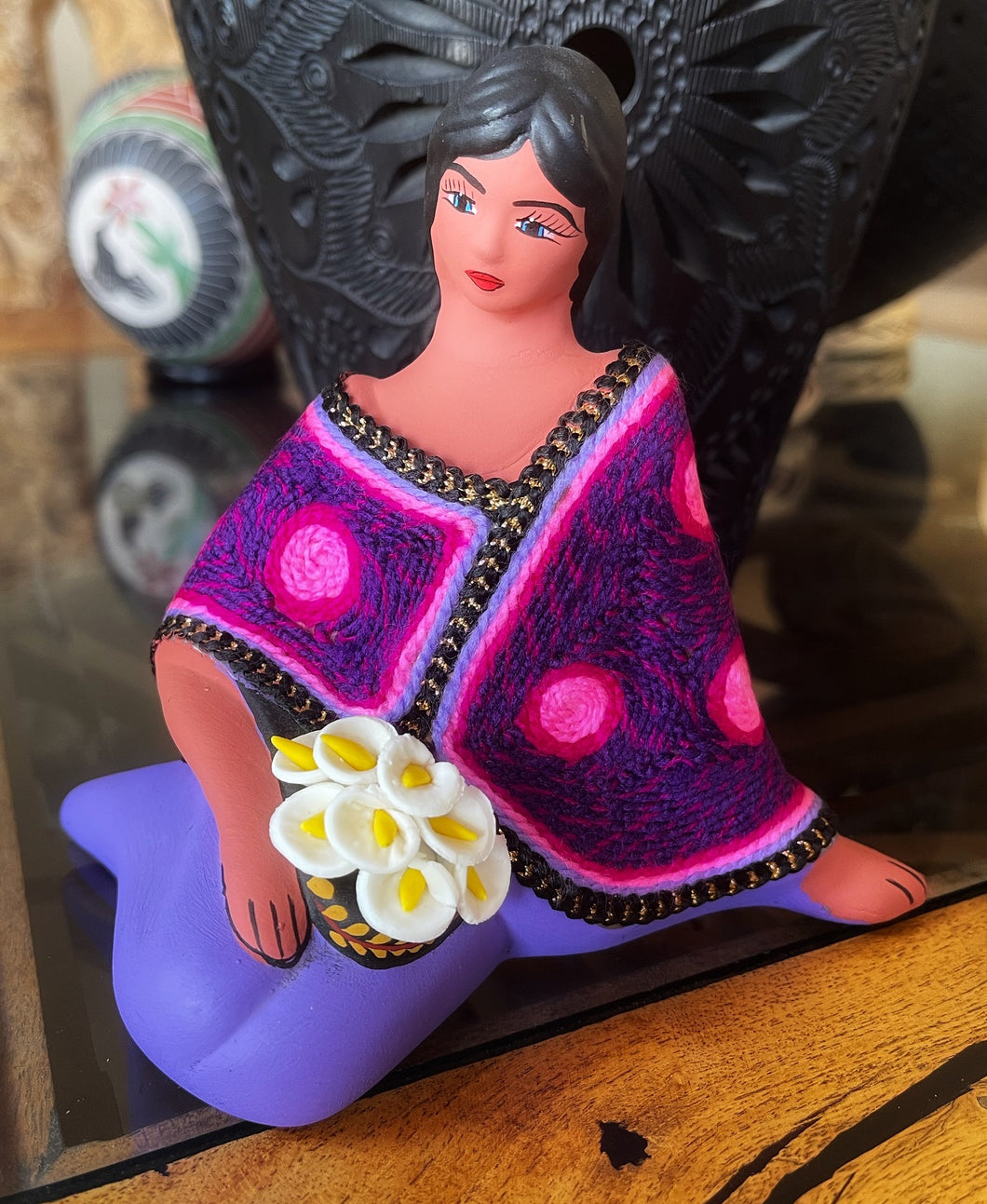 sitting clay doll selling flowers purple shawl