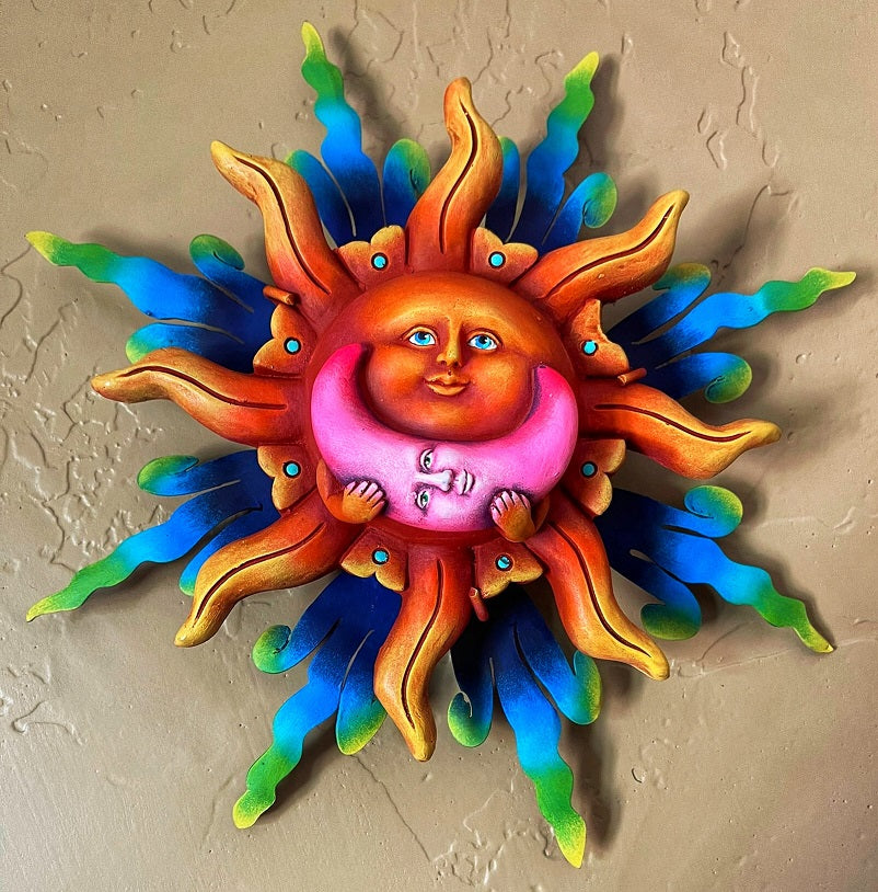 sun holding pink moon wall decor